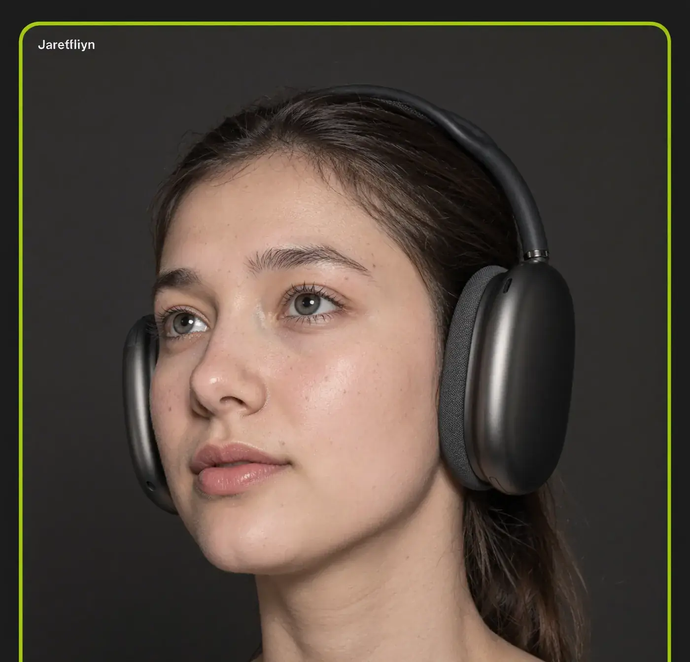 A young woman wears graphite over-ear headphones against a dark backdrop. Sample image created by Quiamo, a brand, marketing and media agency from India.