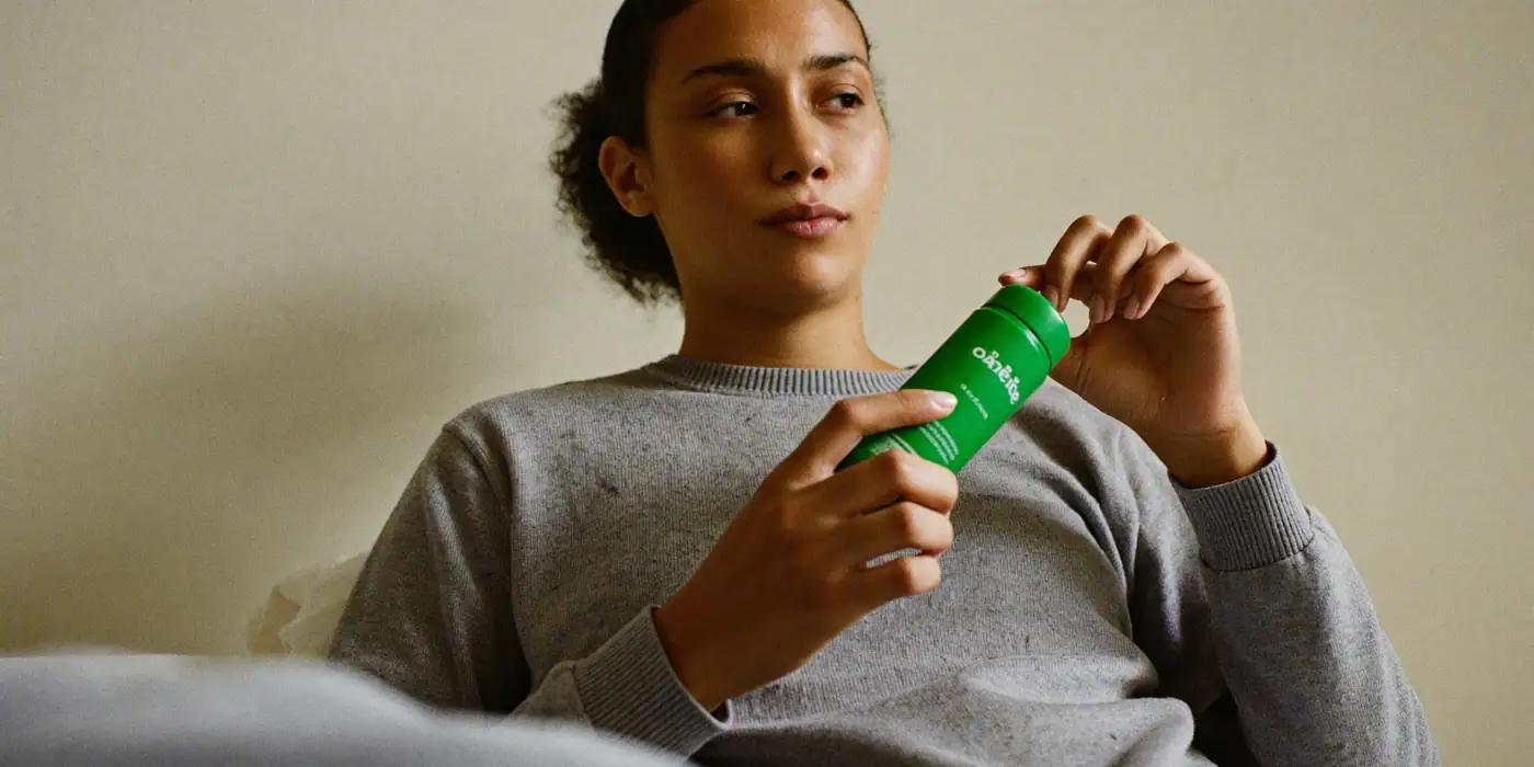 A customer at home holding an everyday product, calm and satisfied, illustrating CAC payback period.