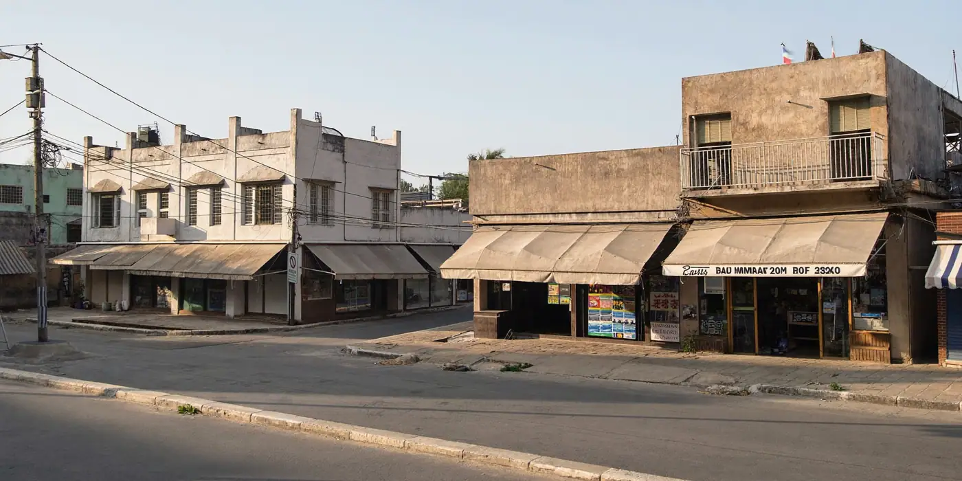 Two similar neighbourhood shopping streets in an Indian town in morning light, illustrating geo experiments marketing.