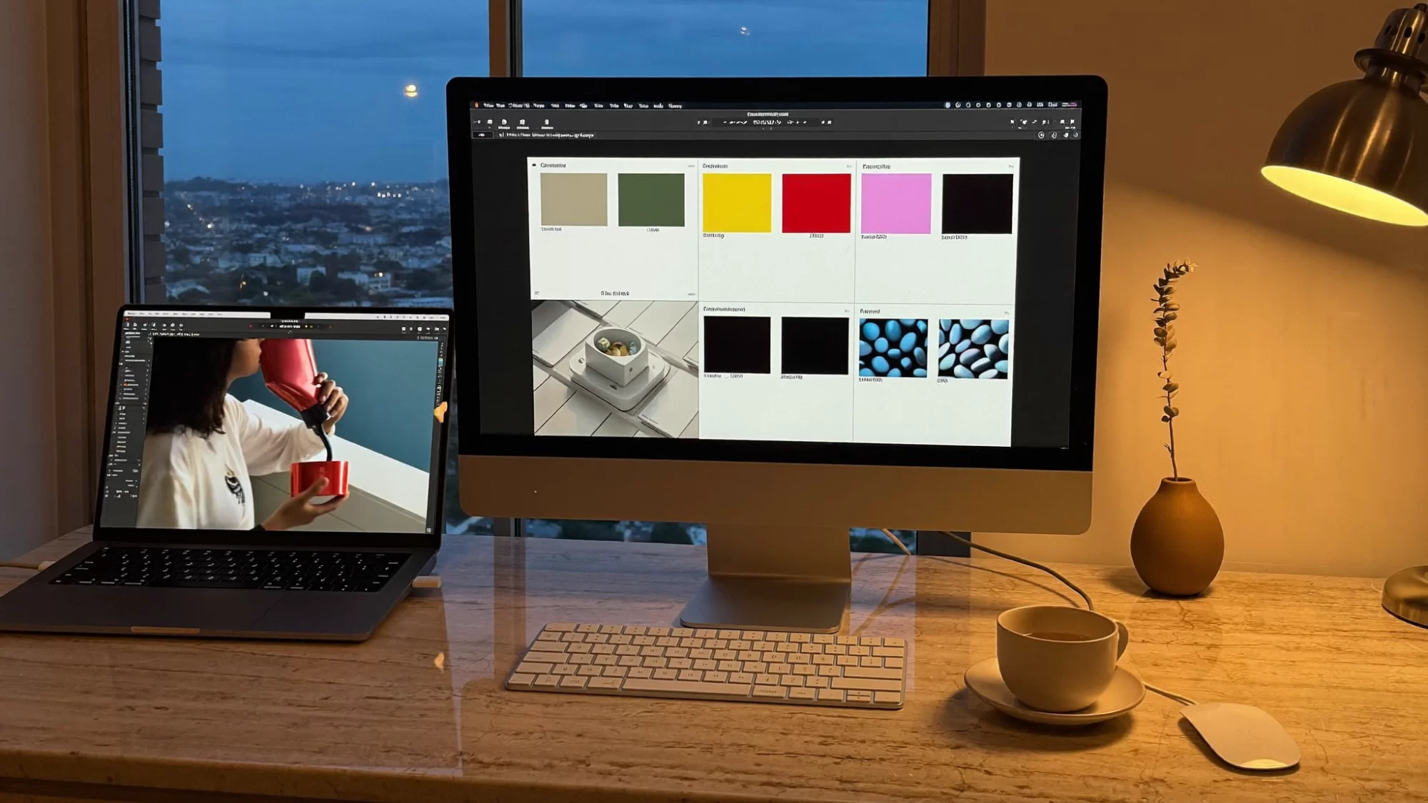 A travertine desk with a laptop and monitor showing a brand moodboard at dusk, a remote creative studio. Sample image created by Quiamo, a brand, marketing and media agency from India.